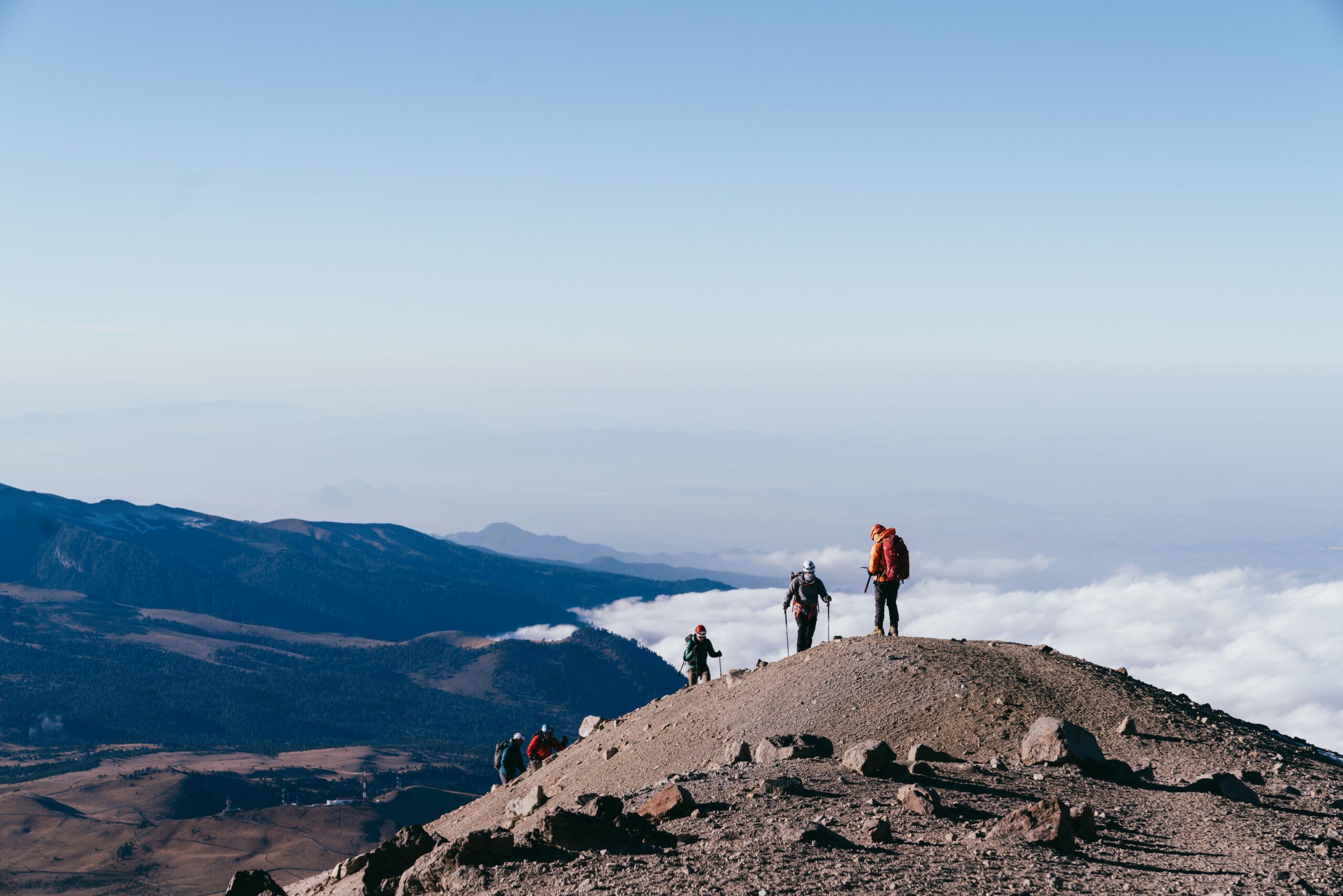 Climber on mountain ridge symbolizing life satisfaction through discomfort.
